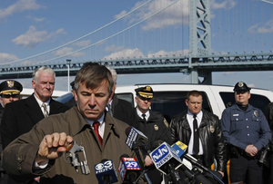 Acting Prosecutor Joshua M. Ottenberg displays a .38-caliber revolver. Bought in Philadelphia, it was used in New Jersey to shoot DRPA Police Officer Matthew Gorman (far right).