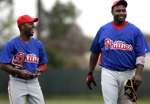 Ryan Howard (right) shares laugh with Jimmy Rollins during break in workout.
