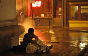 On Moravian Street, a homeless man tries to keep warm on a vent near 15th Street. The alley is a flash point between those who want to help the homeless living on the streets and those increasingly frustrated by the growing, highly visible problem.