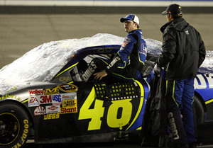 Jimmie Johnson, getting out of his car after Sunday's postponement, is climbing in the standings.
