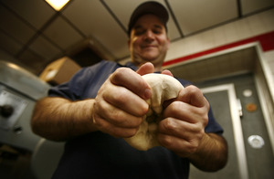 Pete Mavroudis at work in the kitchen of his restaurant, Apollo's Family Pizzeria in Bensalem.