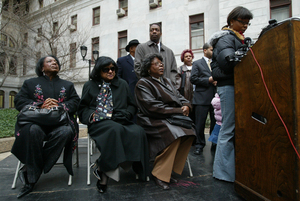 Council members Marian Tasco (from left), Jannie Blackwell, Donna Reed Miller and Darrell Clarke (standing) attend a rally calling for tougher gun laws outside City Hall yesterday.