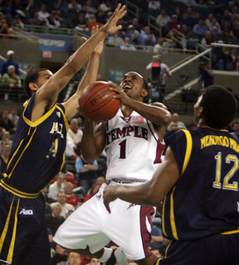 Temple's Chris Clark grabs rebound with as Ruben Guillandeaux and Yves Mekongo Mbala defend.
