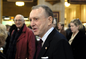 Sen. Arlen Specter chats with commuters as he arrives by train at 30th Street Station for a news conference. He announced the Senate's resolution that HUD should not withhold funding from the Philadelphia Housing Authority in a dispute that could cost it $40 million.