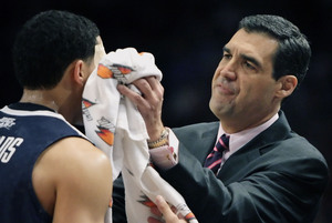 Villanova head coach Jay Wright attends to Scottie Reynolds, who was cut playing Georgetown in the Big East tourney Thursday. Wright said the NCAA invite was "respect for the Big East."