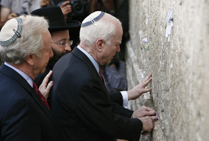 Sen. John McCain touches the Western Wall as he and Sen. Joe Lieberman visit the Jerusalem holy site. He also visited Sderot,which has been hit by Palestinian rockets in recent years.