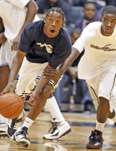 Public League all-star George Baker looks to escape grasp of Eddie Frazier.