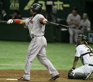 Boston's Manny Ramirez watches the flight of his two-run double off the Athletics' Huston Street in the 10th inning. Behind Ramirez is A's catcher Kurt Suzuki.
