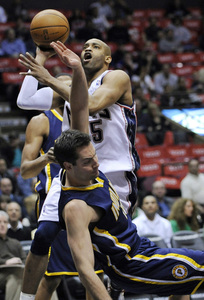 Nets' Vince Carter puts up a shot as Pacers' Jeff Foster falls to court in first quarter.