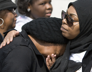 Karinn Goode (left) is comforted by her mother Pamela Goode yesterday at the vigil.