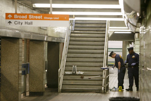 Police search for evidence at the train station at 13th and Market Streets. A man died after an attack there.