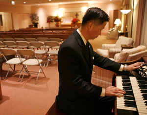 Tom Suh prepares for a Korean funeral at Smith-Corcoran Funeral Home in Palatine, Ill. Suh helps Asian families plan services that incorporate religious and cultural customs.