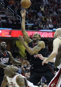 The Sixers' Andre Iguodala puts up a shot against the Cavs' Joe Smith (bottom) and Zydrunas Ilgauskas (right) on Sunday. Iguodala played in the playoffs as a rookie.