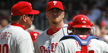 Phillies pitcher Brett Myers (facing camera) talks with (from left) pitching coach Rich Dubee, catcher Carlos Ruiz and second baseman Chase Utley.