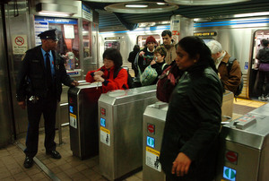 SEPTA Officer Dell Foster patrols the 11th Street station of the Market-Frankford line. After recent attacks, one of them fatal, SEPTA will increase its policing during after-school hours.