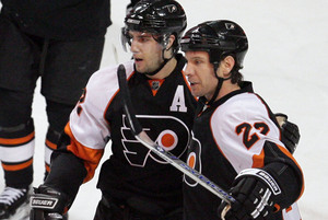 Mike Knuble (right) celebrates a goal with Simon Gagne. The Gagne-Knuble-Danny Briere line keyed the team's fast start.