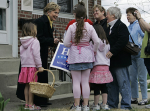 Sen. Hillary Rodham Clinton campaigns door-to-door with Rep. Joe Sestak's daughter, Alexandra Sestak (left, holding basket), in Drexel Hill yesterday.