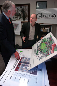 Rowan University president Donald Farish (left) and Glassboro administrator Joseph A. Brigandi talk about the project to link downtown with the university. Groundbreaking is set for June.