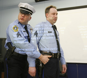 Philadelphia Police Sgt. D.F. Pace puts his fingers into Sgt. Martin Klepac's pocket, an illegal move during a frisk.