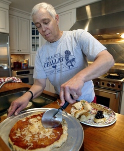 Carver slices his Passover Pizza.