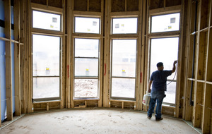 A home under construction near Houston has insulation sprayed around its windows. New-home starts fell 11.9 percent in March from February.