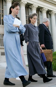Two members of the polygamous Fundamentalist Church of Jesus Christ of Latter Day Saints leave court with their attorney.