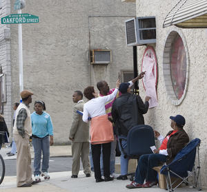 People mill around polling place at 21st and Oakford streets yesterday.