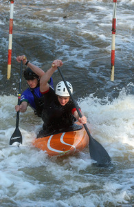 With Rick Powell in the bow and Casey Eichfeld in the stern, their two-man kayak plows through whitewater in the slalom event. Similar to a ski slalom, the whitewater event involves navigating gates.