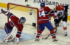 Flyers' Joffrey Lupul scores between Canadiens goalie Carey Price (left) and Roman Hamrlik during third period.