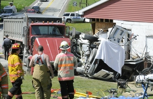 Emergency workers survey the scene of yesterday's accident in Somerset Township, western Pennsylvania, where a tractor-trailer slammed into a van carrying residents of a group home.