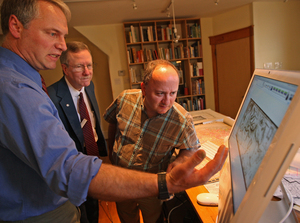 Local historians (from left) Torben Jenk, Rich Remer and Ken Milano discuss a map, done after the British army left Philadelphia, that shows a fort at the Delaware River site.