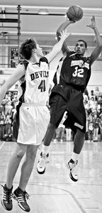 Timber Creek's Tyler Hines, here shooting over Hammonton's Kevin Kohr, has committed to Maryland-Eastern Shore.