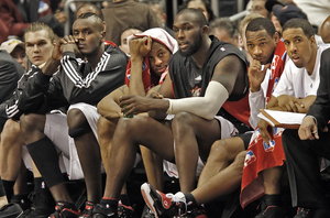 Dejected Sixers watch from the bench as the season's final minutes tick away in a blowout loss to the Pistons.