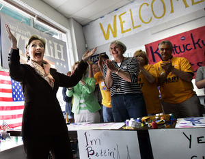 Sen. Hillary Rodham Clinton gets an ovation from supporters at her campaign headquarters in Louisville, Ky. She said yesterday that she had the best plan for easing the pain of gas prices.