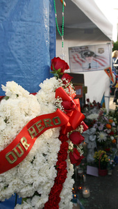 Flowers jam memorial to Sgt. Liczbinski on Schiller Street.