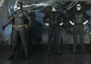 The Batman costume worn by Christian Bale in "The Dark Knight" (left) is on display at the Met along with fashions by Emporio Armani and Pierre Cardin.