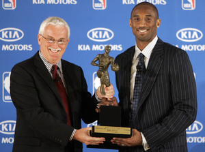 The Lakers' Kobe Bryant accepts the NBA MVP award from Alex Fedorak, director of public relations with Kia Motors.
