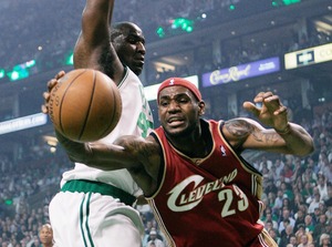 Cleveland's LeBron James reaches for the ball past Boston's Kendrick Perkins after losing control on a drive.