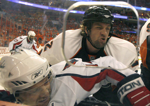 Flyers defenseman Derian Hatcher, slamming the Capitals' Eric Fehr into the boards, is fighting through ankle, knee and hip injuries.