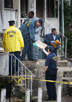 Philadelphia police crime scene unit officers with homicide detectives at the house scene along 5400 block of Windsor in West Philadelphia on Thursday morning May 8, 2008. 