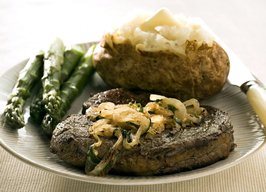 Sweet onions with tarragon bring that Bearnaise flavor to rib-eye steak, with fewer calories.