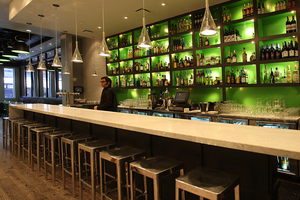 At Apothecary, the barstools and the bottles are lined up in anticipation of the customers who will come with its opening.