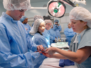 In an operating room at Deborah Heart and Lung Center in Browns Mills, nurse Jackie Herron shows Ryan Noone how to use a sternal retractor. The Future Nurses of America club from Pemberton Township High School toured the hospital as part of National Nurses Week. "You get to see a lot of the stuff you don't get to see unless you're in a hospital bed," Noone said.