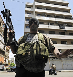 Shiite gunmen prepare to seize a building. Hezbollah took over some Beirut areas but pulled back from a larger showdown.