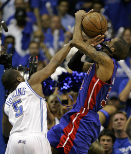 The Pistons' Richard Hamilton is hit by the Magic's Keyon Dooling, who was called for both a foul and a technical foul.