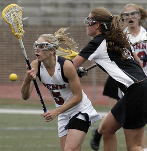 Quakers midfielder Kaitlin Farmer (5) cuts off Colgate's Molly Carroll. Rachel Manson scored three goals to lead Penn into the NCAA tournament quarterfinals.