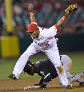 Angels shortstop Erick Aybar alights after completing his throw for a double play. Out at second is the White Sox' Juan Uribe.