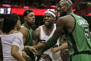 Gloria James gets an earful from her son, the Cavaliers' LeBron James. She jumped out of her seat after a foul by the Celtics' Paul Pierce (second from left) on her son. Kevin Garnett is at right.