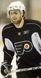 Braydon Coburn's injured left eye reopened Tuesday night, and he wore a face shield while practicing yesterday in Voorhees.