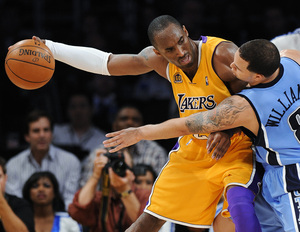 Lakers' Kobe Bryant, who has a sore back, holds ball away from Jazz' Deron Williams in fourth quarter of Game 5.